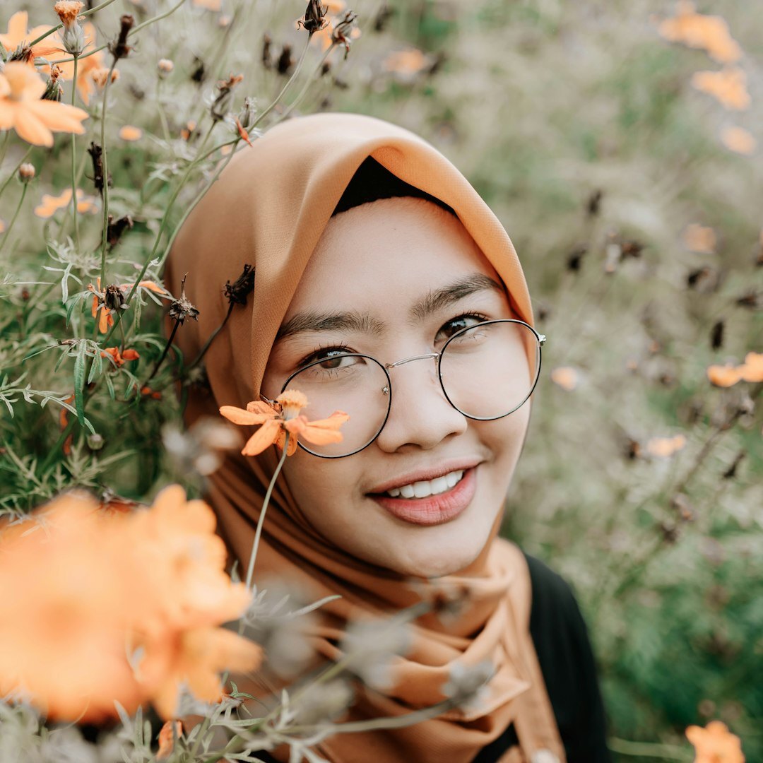Professional Malaysian woman podcast host smiling confidently